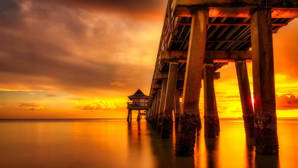 Naples Pier on the beach at sunset in Naples, Florida, USA.